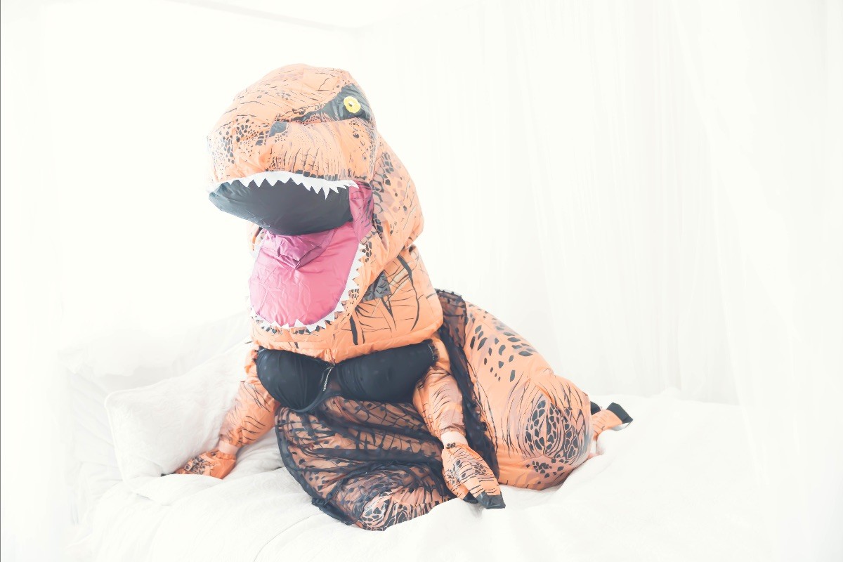 Woman dressed in t-rex costume photoshoot